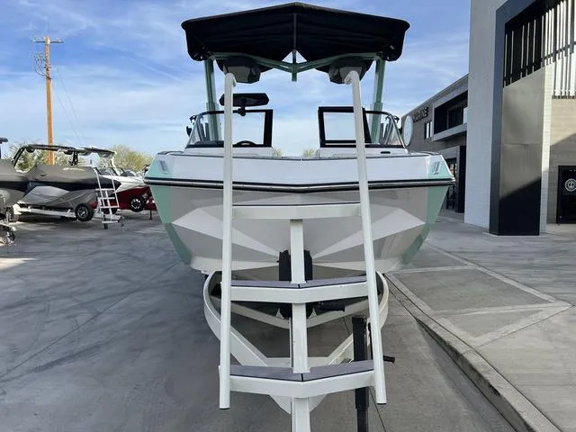 Slide: The Image of 2023 Nautique Super Air Nautique G25 boat with ladder, parked outdoors. - 3