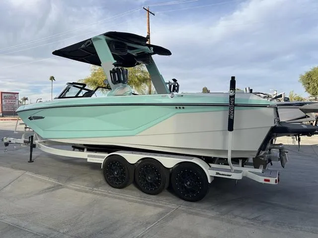 Slide: The Image of 2023 Nautique Super Air Nautique G25 boat on trailer, mint green and white design. - 6