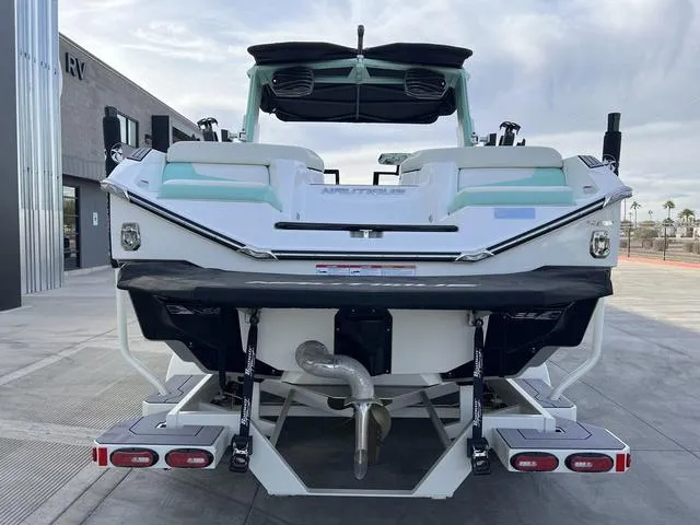 Slide: The Image of 2023 Nautique Super Air Nautique G25 boat, rear view, parked outdoors. - 7