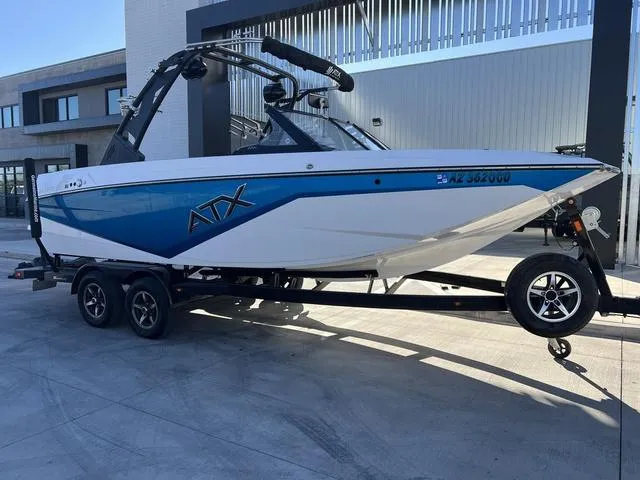Slide: The Image of 2022 ATX Boats 22 TYPE-S on trailer, blue and white design, parked outdoors. - 2