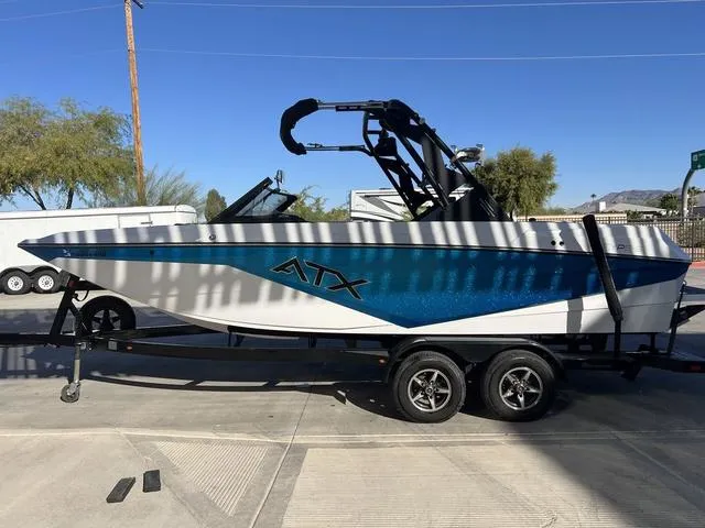 Slide: The Image of 2022 ATX Boats 22 TYPE-S on trailer, blue and white design, parked outdoors. - 5