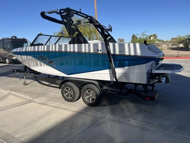 Slide: The Image of 2022 ATX Boats 22 TYPE-S on trailer, blue and white design, parked outdoors. - 6