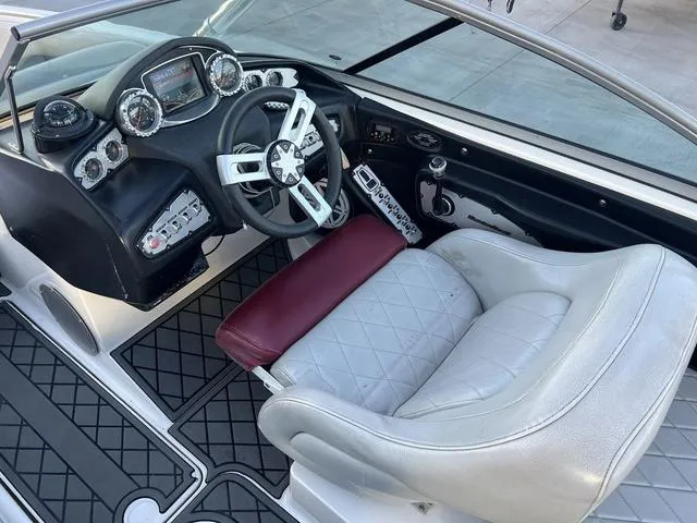 Slide: The Image of 2010 MasterCraft X45 boat cockpit with steering wheel, dashboard, and cushioned seat. - 11
