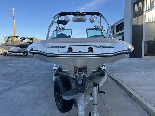 Slide: The Image of 2010 MasterCraft X45 boat on trailer, front view, parked outdoors. - 3