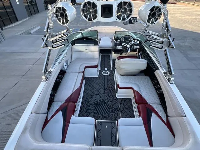 Slide: The Image of 2010 MasterCraft X45 boat interior with white and red seating, advanced sound system, and sleek design. - 9