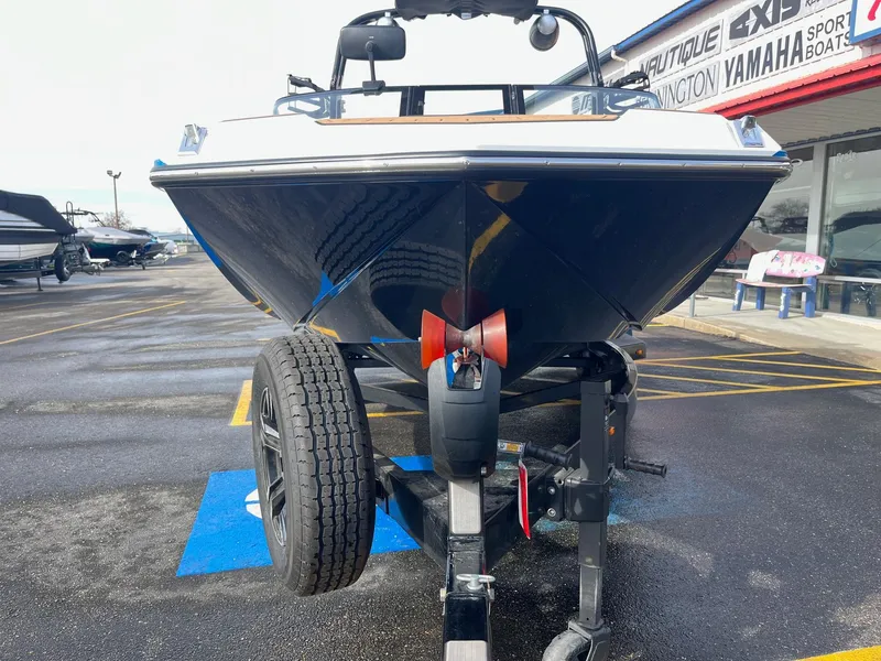 Slide: The Image of 2020 Nautique GS22 boat on trailer at dealership parking lot. - 10