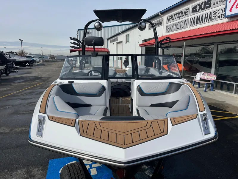 Slide: The Image of 2020 Nautique GS22 boat with sleek design, parked outside a dealership. - 11