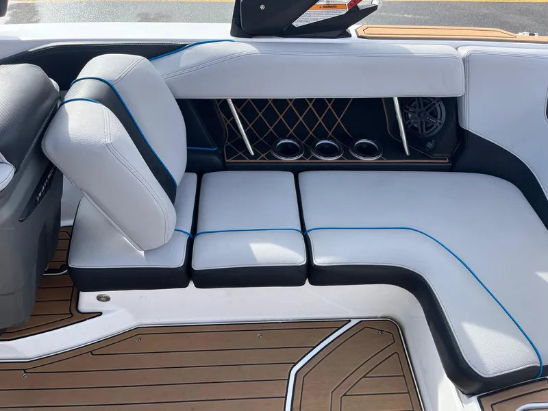 Slide: The Image of 2020 Nautique GS22 boat interior with white and blue cushioned seating. - 20