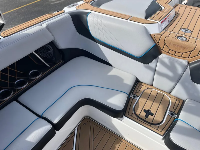 Slide: The Image of 2020 Nautique GS22 boat interior with cushioned seating and teak flooring. - 21