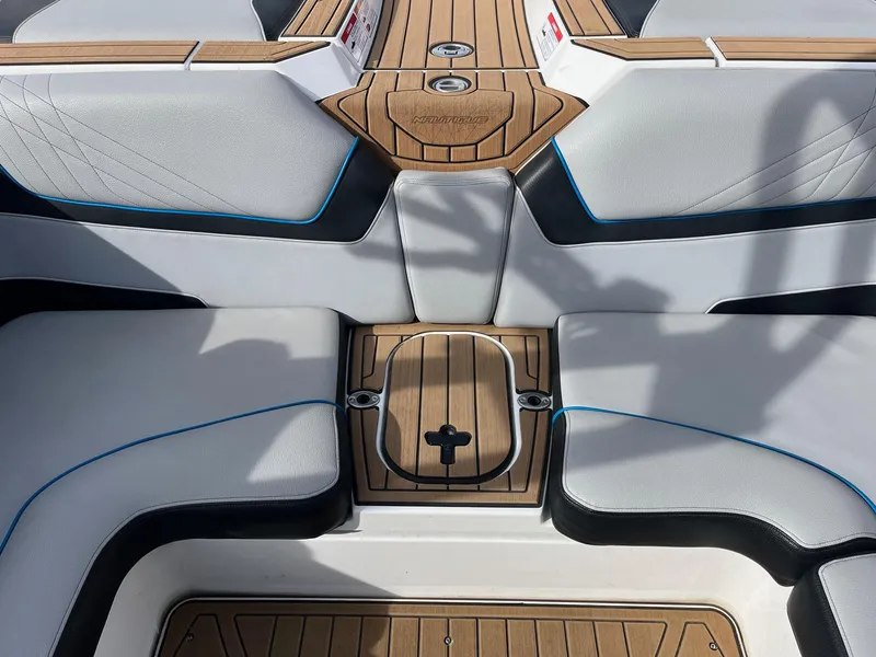 Slide: The Image of 2020 Nautique GS22 boat interior with sleek seating and teak flooring. - 22