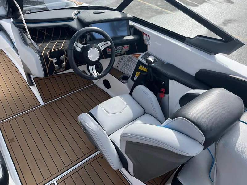 Slide: The Image of 2020 Nautique GS22 boat interior with modern dashboard and comfortable seating. - 26