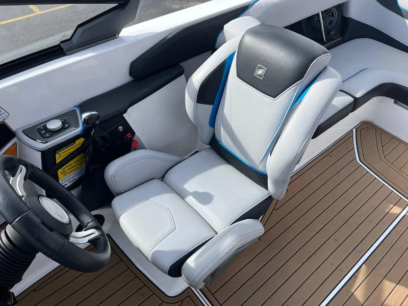 Slide: The Image of 2020 Nautique GS22 interior with sleek captain's chair and modern dashboard controls. - 27