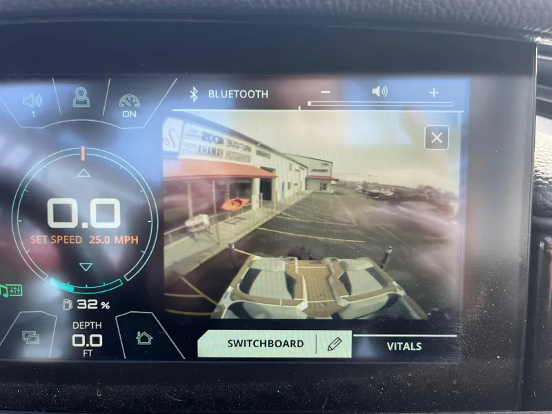 Slide: The Image of 2020 Nautique GS22 dashboard display showing speed, depth, and rear camera view. - 30