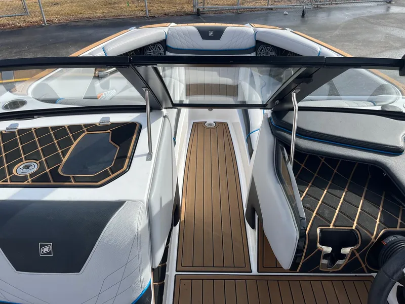 Slide: The Image of 2020 Nautique GS22 boat interior with sleek design and wood-patterned flooring. - 32