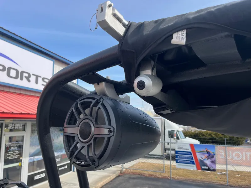 Slide: The Image of 2020 Nautique GS22 boat speaker and camera setup at a sports dealership. - 34