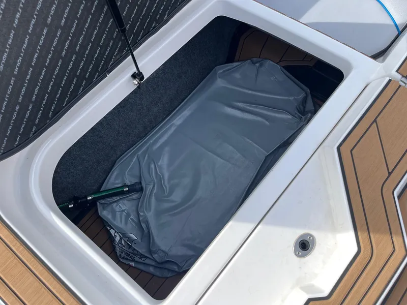 Slide: The Image of Storage compartment of a 2020 Nautique GS22 boat, featuring interior details and equipment. - 37