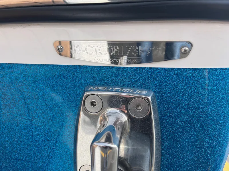 Slide: The Image of 2020 Nautique GS22 boat with metallic blue finish and identification plate. - 39