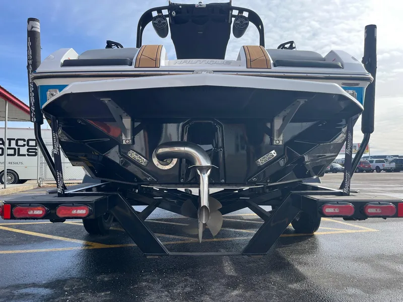 Slide: The Image of 2020 Nautique GS22 boat rear view on trailer in parking lot. - 6