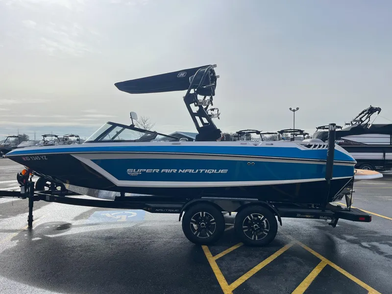 Slide: The Image of 2020 Nautique GS22 boat on trailer in parking lot, side view. - 8