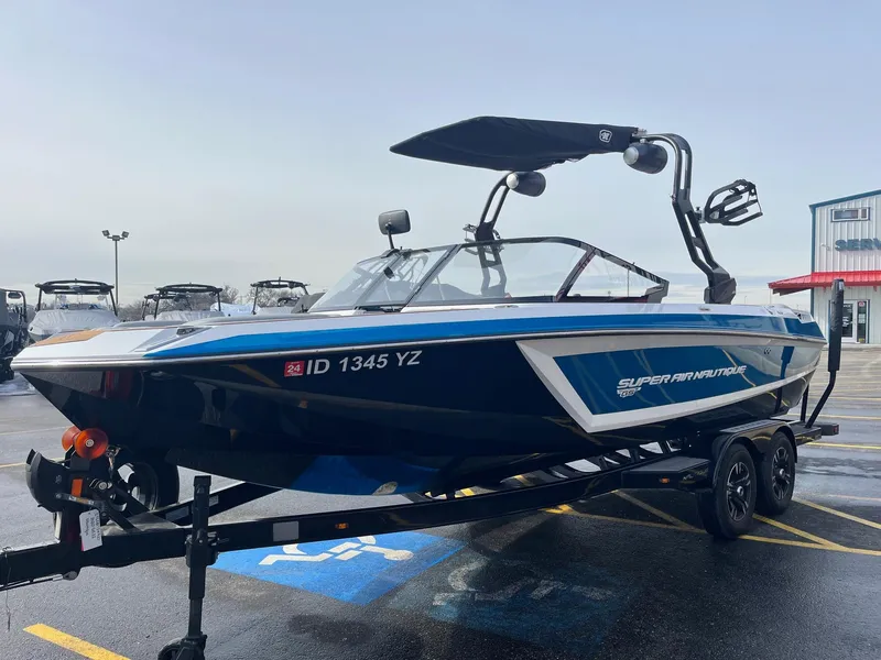 Slide: The Image of 2020 Nautique GS22 boat on trailer in parking lot. - 9