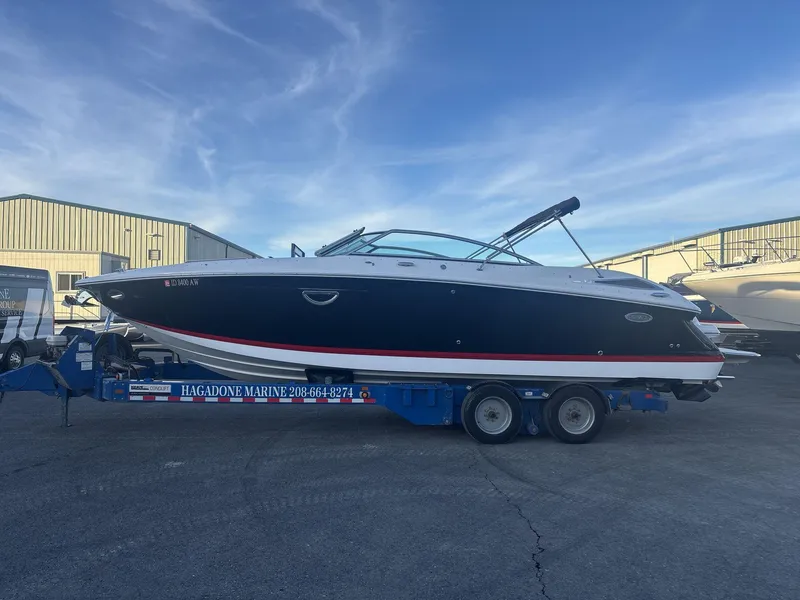Slide: The Image of 2016 Cobalt 302 boat on trailer at Hagadone Marine, clear sky background. - 1