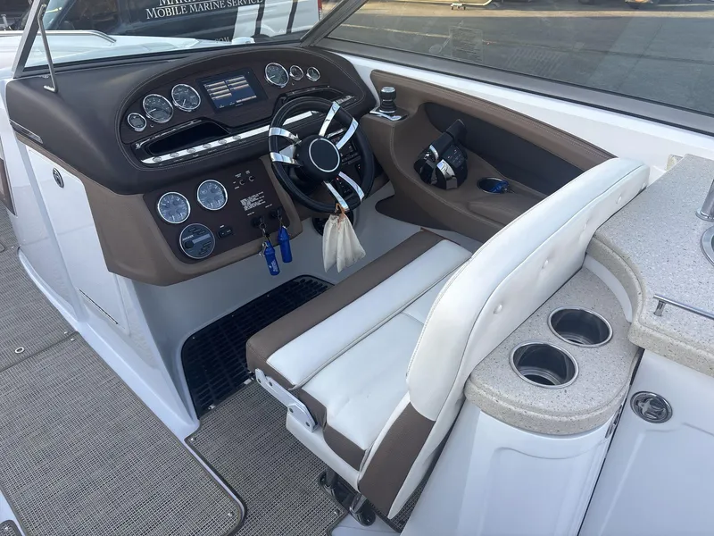 Slide: The Image of 2016 Cobalt 302 boat cockpit with steering wheel and control panel. - 10