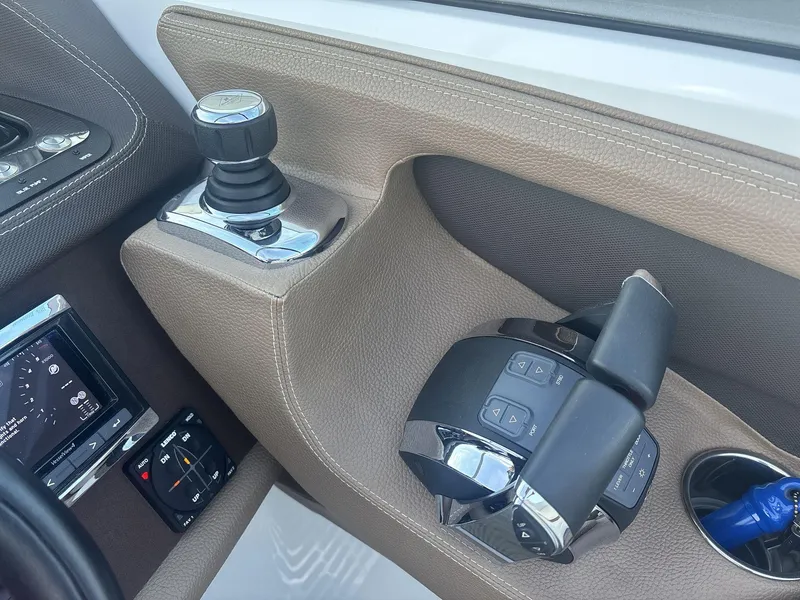Slide: The Image of Interior controls of a 2016 Cobalt 302 boat, featuring joystick and throttle. - 12
