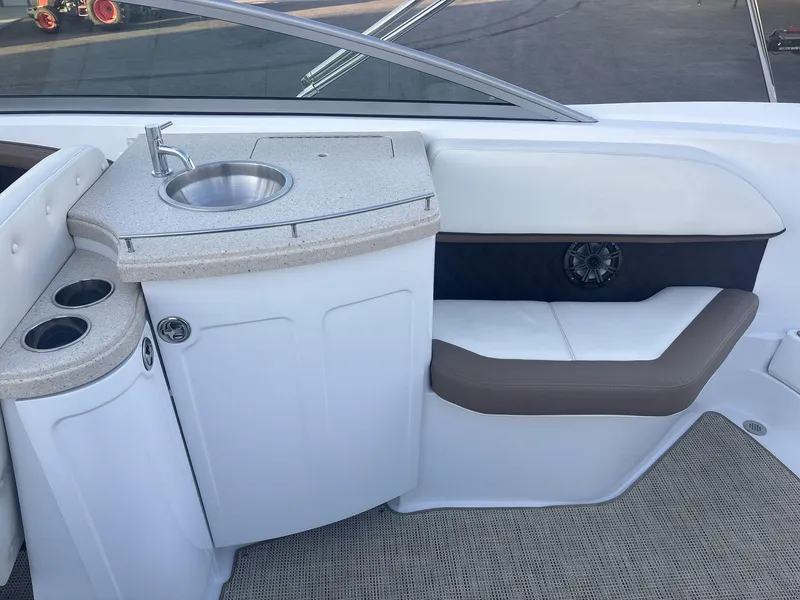 Slide: The Image of Interior of a 2016 Cobalt 302 boat featuring a sink and seating area. - 15