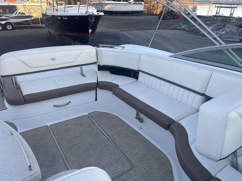 Slide: The Image of Interior of a 2016 Cobalt 302 boat with white and brown seating. - 16