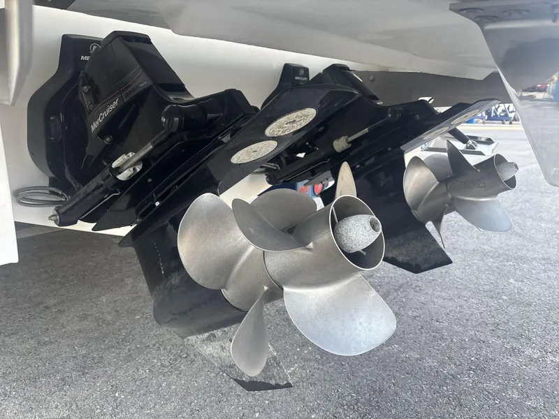 Slide: The Image of Close-up of 2016 Cobalt 302 boat propellers and MerCruiser outdrive on pavement. - 18