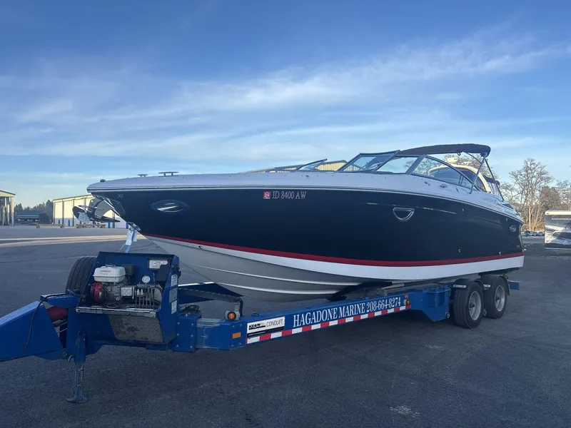 Slide: The Image of 2016 Cobalt 302 boat on trailer at Hagadone Marine, clear sky background. - 2