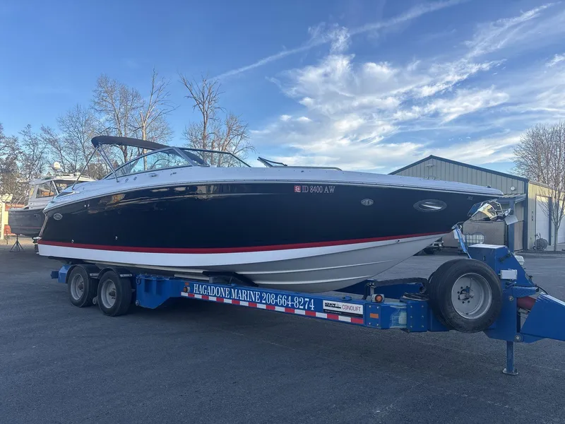 Slide: The Image of 2016 Cobalt 302 boat on trailer at marina, clear sky background. - 3