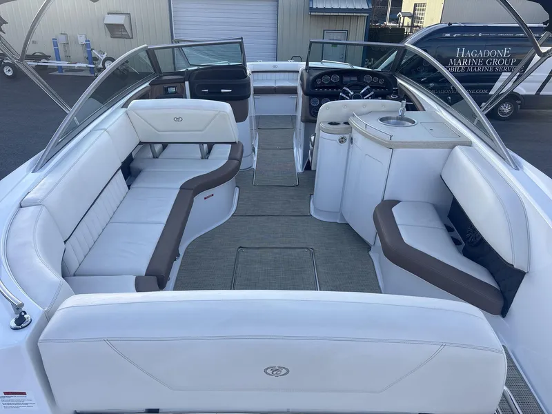 Slide: The Image of 2016 Cobalt 302 boat interior with white seating and helm, docked at marina. - 6