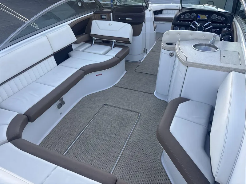 Slide: The Image of Interior of a 2016 Cobalt 302 boat with white and brown seating. - 7