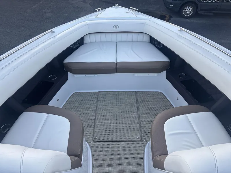 Slide: The Image of Interior of a 2016 Cobalt 302 boat with white and brown seating. - 8