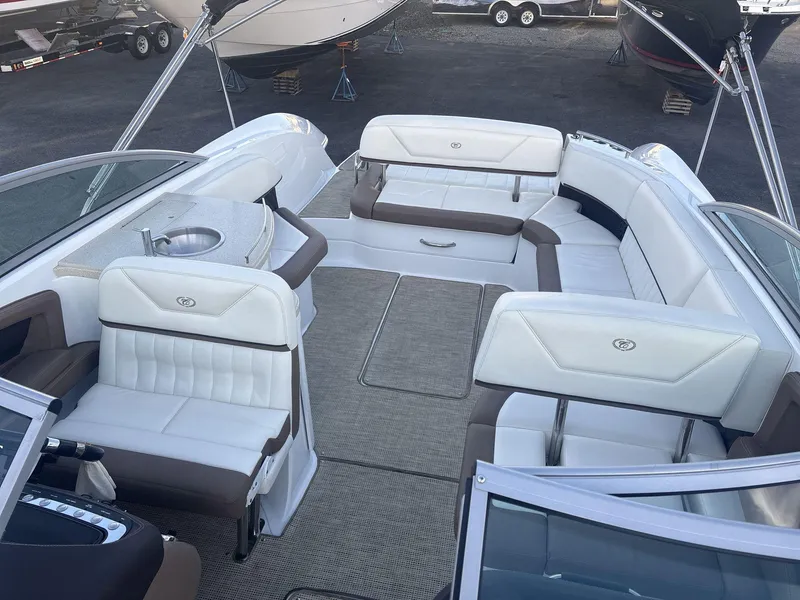 Slide: The Image of Interior of a 2016 Cobalt 302 boat with white and brown seating. - 9