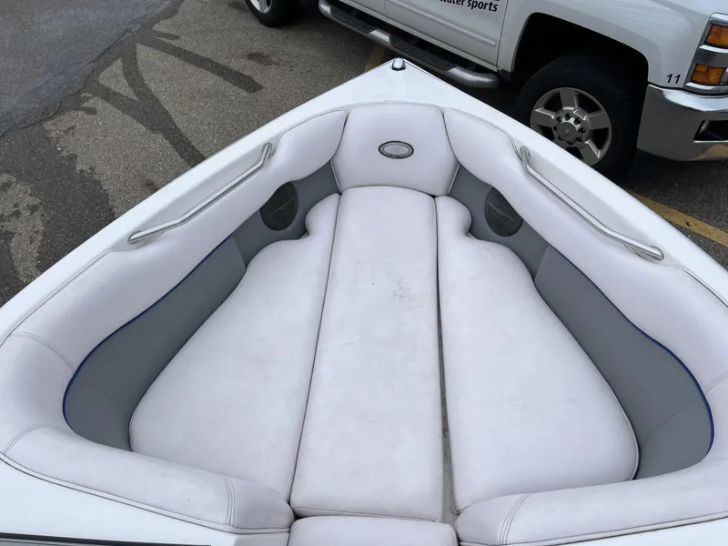 Slide: The Image of 2004 Supra Launch boat interior with white cushioned seating and gray accents. - 18