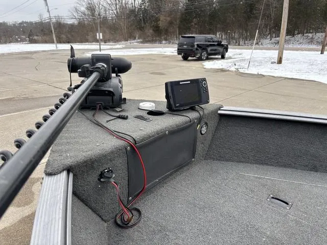 Slide: The Image of 2015 Lund Impact 1875 SS boat with trolling motor and fish finder in snowy parking lot. - 12