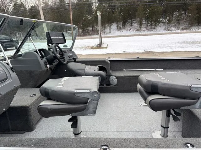 Slide: The Image of 2015 Lund Impact 1875 SS boat interior with seating and steering console. - 13