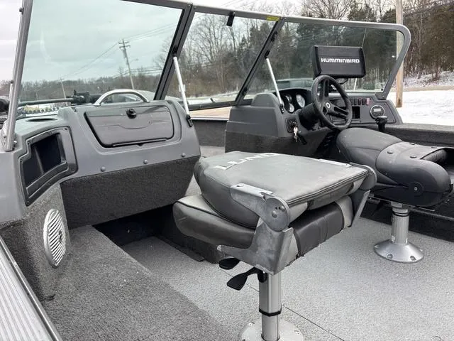 Slide: The Image of 2015 Lund Impact 1875 SS boat interior with seating and steering console. - 14