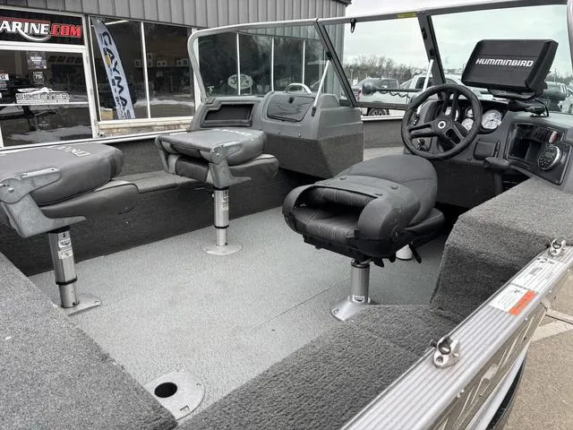 Slide: The Image of 2015 Lund Impact 1875 SS boat interior with seating and Humminbird electronics. - 6