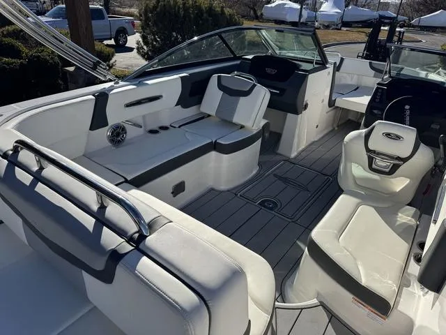Slide: The Image of 2024 Chaparral 247 SSX boat interior with white seating and modern dashboard. - 10