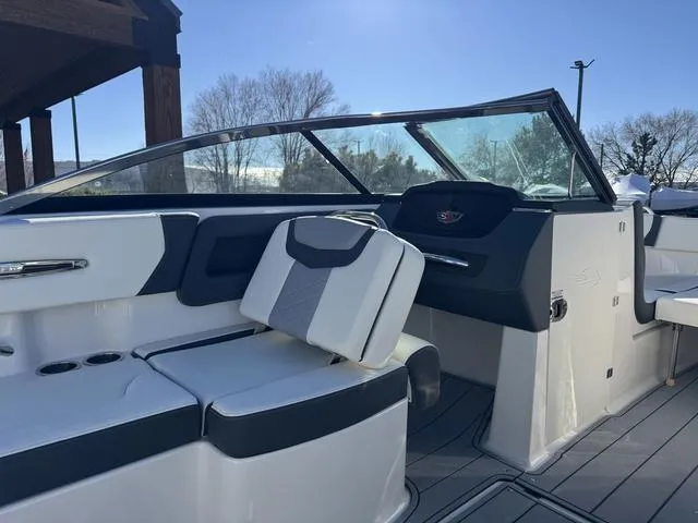 Slide: The Image of 2024 Chaparral 247 SSX boat interior with sleek seating and modern dashboard design. - 12