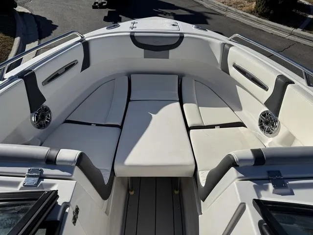Slide: The Image of 2024 Chaparral 247 SSX boat interior with white seating and modern design. - 14