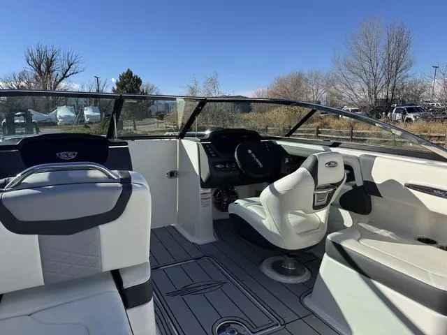 Slide: The Image of 2024 Chaparral 247 SSX boat interior with sleek seating and modern dashboard design. - 17