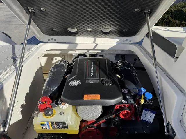 Slide: The Image of 2024 Chaparral 247 SSX engine compartment with Volvo Penta motor, open hatch view. - 19