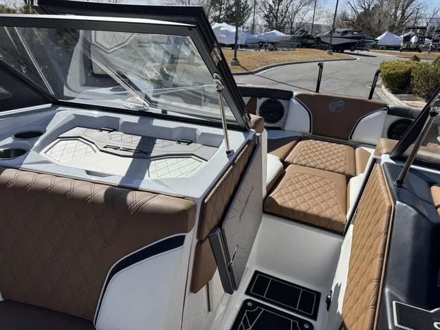 Slide: The Image of Interior of 2025 Tigé 24RZX boat with luxurious brown seating and modern design. - 10