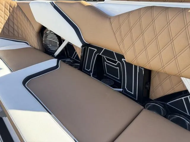 Slide: The Image of 2025 Tigé 24RZX boat interior with tan diamond-stitched upholstery and integrated speaker system. - 12