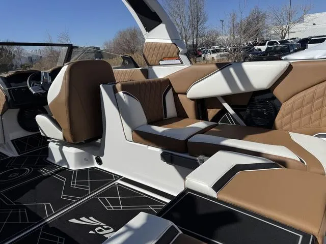 Slide: The Image of 2025 Tigé 24RZX boat interior with brown and white seating, modern design, and geometric flooring. - 13