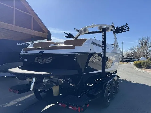 Slide: The Image of 2025 Tigé 24RZX boat on trailer, parked outdoors under clear sky. - 5